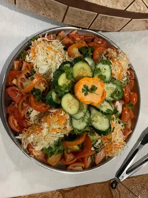 a bowl of food with vegetables and cheese on a table at Hotel Palenque Tarrazu in San Marcos