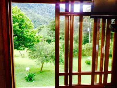 a window with a view of a field of trees at Lemon House Monteverde in Monteverde Costa Rica