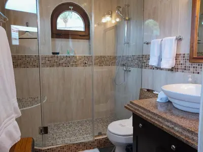 a bathroom with a shower and a toilet and a sink at Playa Flamingo penthouse with pacific sunset views - Flamingo Rose Vista in Playa Flamingo