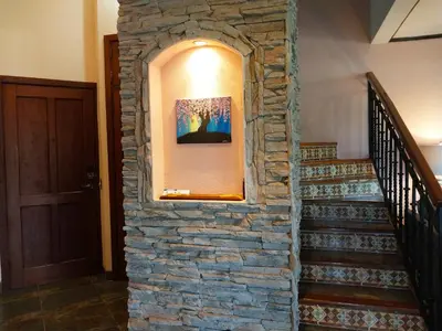 a stone wall in a hallway with a staircase at Playa Flamingo penthouse with pacific sunset views - Flamingo Rose Vista in Playa Flamingo