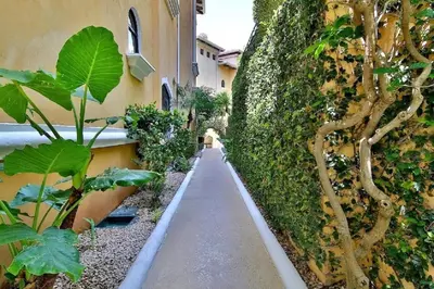 a garden path next to a building with plants at Playa Flamingo penthouse with pacific sunset views - Flamingo Rose Vista in Playa Flamingo