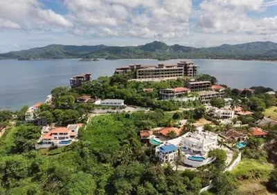 an aerial view of a resort next to the water at Playa Flamingo penthouse with pacific sunset views - Flamingo Rose Vista in Playa Flamingo