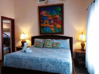 a bedroom with a bed with a stuffed animal on it at Playa Flamingo penthouse with pacific sunset views - Flamingo Rose Vista in Playa Flamingo