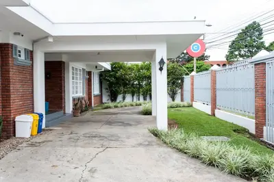 an empty sidewalk in front of a brick building at Capital Hostel de Ciudad in San José
