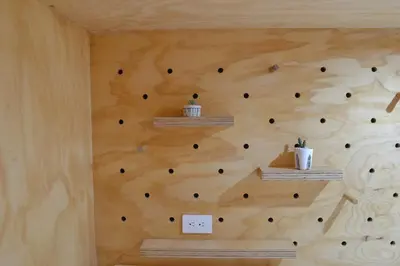 a wall made out of wood with a climbing wall at Capital Hostel de Ciudad in San José