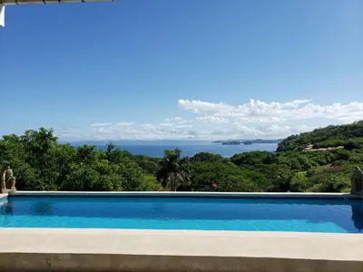 a swimming pool with a view of the water at Pura Vista Hotel in Ocotal