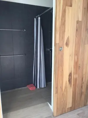 a bathroom with a shower and a shower curtain at Pura Vista Hotel in Ocotal