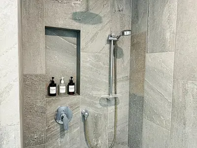a shower with two bottles of wine on a wall at Elan at Ballena Beach in Uvita