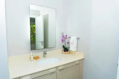 a bathroom with a sink and a mirror at Elan at Ballena Beach in Uvita
