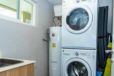 a washer and dryer in a kitchen next to a sink at Elan at Ballena Beach in Uvita