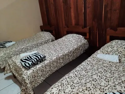 two beds sitting next to each other in a room at Arenal Xilopalo in Fortuna