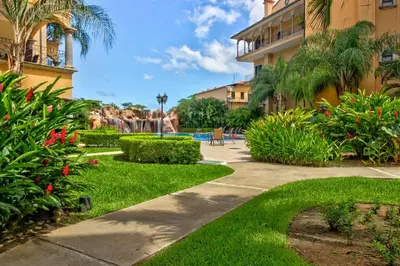 a walkway through the gardens of a resort at Sunrise 22 in Tamarindo
