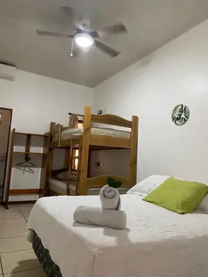 a bedroom with a bed with a towel on it at Ukinca in Uvita