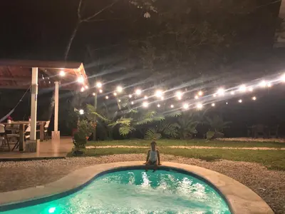 a person sitting in a pool at night at Ukinca in Uvita