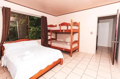 a bedroom with a bed and a bunk bed at Ukinca in Uvita
