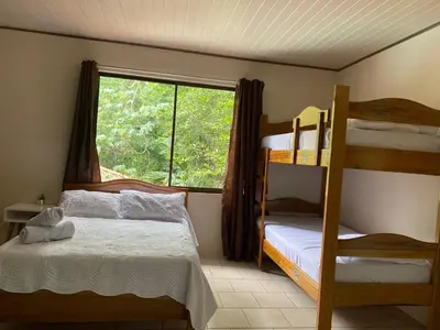 a bedroom with two bunk beds and a window at Ukinca in Uvita