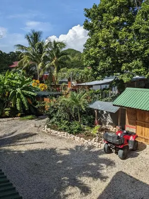 a red tractor parked next to a small building at Casa Calocita in Santa Teresa Beach