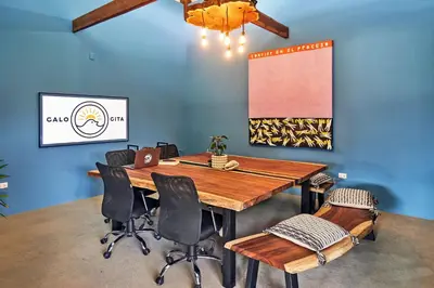 a conference room with a wooden table and chairs at Casa Calocita in Santa Teresa Beach