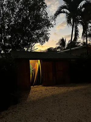 a house with a garage with a surfboard in it at Casa Calocita in Santa Teresa Beach