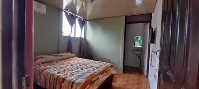 a small bedroom with a bed and a window at Hostal y cabinas anita-and rafting tour! in Siquirres