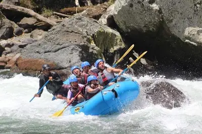 a group of people in a raft on a river at Hostal y cabinas anita-and rafting tour! in Siquirres