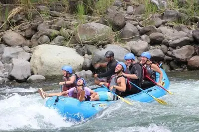 a group of people in a raft on a river at Hostal y cabinas anita-and rafting tour! in Siquirres