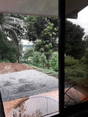 a view of a yard from a window at Hostal y cabinas anita-and rafting tour! in Siquirres