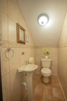 a small bathroom with a toilet and a sink at Green Villas El Coco in Coco