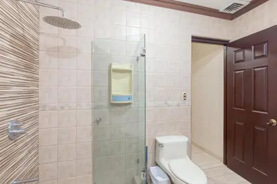 a bathroom with a toilet and a glass shower at Green Villas El Coco in Coco
