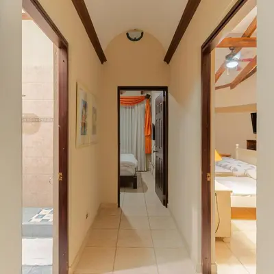 a hallway leading to a bedroom with a bed at Green Villas El Coco in Coco