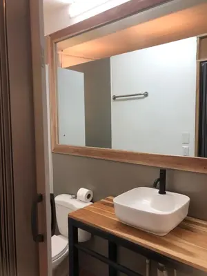 a bathroom with a sink and a mirror at Rancho Capulin B&B in Tarcoles