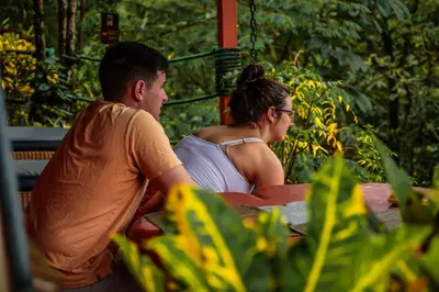 a man and a woman sitting at a table at Santa Juana Lodge & Nature Reserve in Quepos