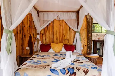 a bedroom with a bed with a canopy at Monteverde Romantic Cabañas 5minutes mtv park in Monteverde Costa Rica
