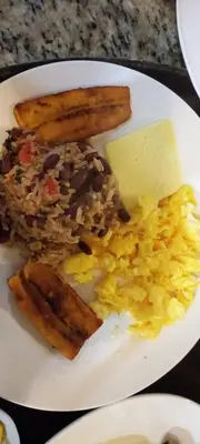 a plate of food with rice and beans and eggs at Monteverde Romantic Cabañas 5minutes mtv park in Monteverde Costa Rica
