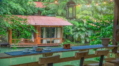 a wooden table with a meal on it in front of a house at Cabañas del Lago in Fortuna