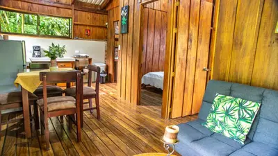 a living room with a blue couch and a table at Cabañas del Lago in Fortuna