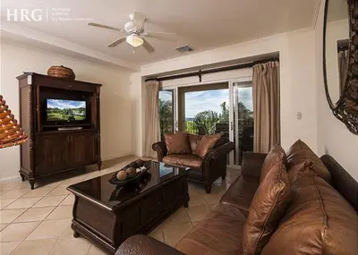a living room with a couch and a tv at Ocean View Condo in Los Sueños in Herradura
