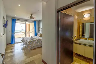 a bedroom with a bed and a bathroom with a tub at Breakwater Point 602 in Jacó