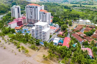 an aerial view of a resort with palm trees at Breakwater Point 602 in Jacó