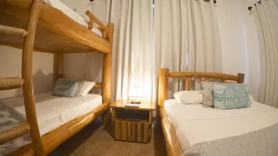 a bedroom with two bunk beds and a window at Villas Welcome to Heaven in Carrillo