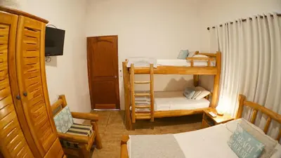 a room with two bunk beds and a chair at Villas Welcome to Heaven in Carrillo