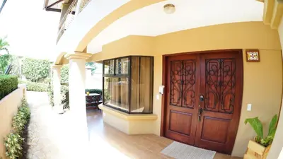 a house with a wooden door in a hallway at Villas Welcome to Heaven in Carrillo