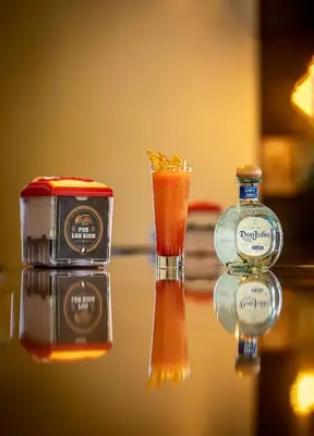 a drink and a bottle of alcohol on a table at Hotel Los Rios in Guácimo