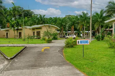 a sign in front of a house with a driveway at Hotel Los Rios in Guácimo