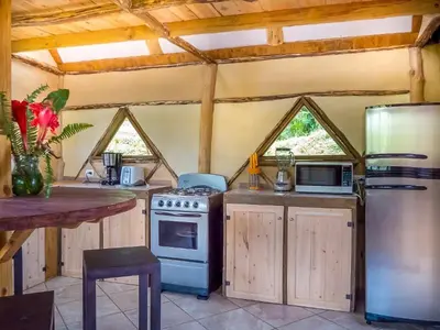 a kitchen with a stove and a refrigerator at La Cima del Mundo in Chimirol