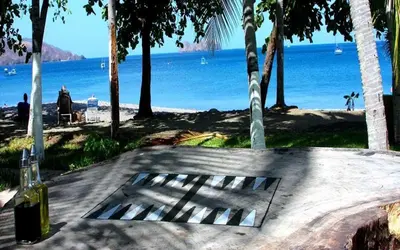 a view of a beach with a grate in the ground at Hotel La Gaviota Tropical in Playa Hermosa