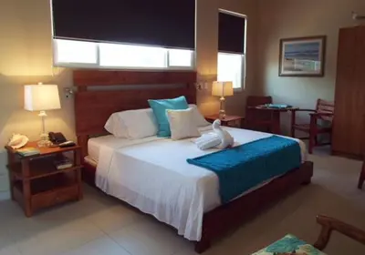 a bedroom with a large bed with a white bird on it at Hotel La Gaviota Tropical in Playa Hermosa