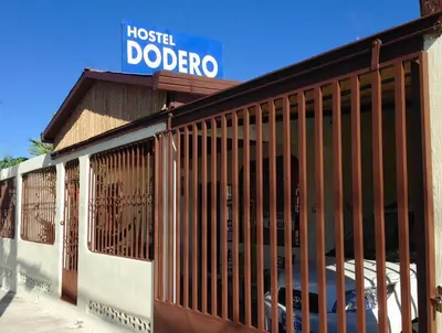 a building with wooden bars on the side of it at Hostel Dodero in Liberia
