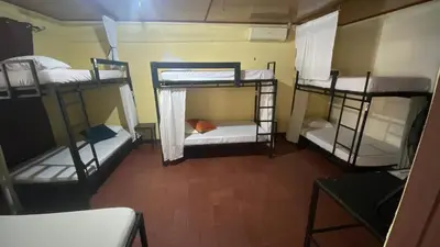 a room with three bunk beds in a room at Hostel Pura Vida en Liberia in Liberia