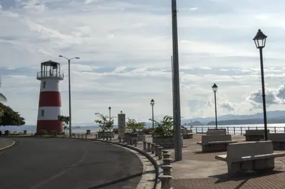 a red and white lighthouse sitting next to a street at Hotel Sol Puntarenas in Puntarenas